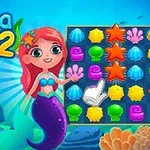 Nàng tiên cá hoạt hình với mái tóc đỏ đứng cạnh bảng màu sắc đầy các hình dạng sao biển, vỏ sò, và san hô trong khung cảnh dưới nước