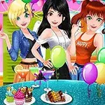 Ba cô gái với trang phục thời trang đứng phía sau bàn trang trí nhiều bong bóng và có đĩa bánh ngọt trên bàn trong một bữa tiệc tại gia