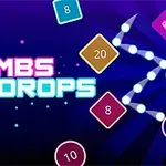 Nền màu tím đậm với chữ BOMBS và DROPS nổi bật, xung quanh là các khối hình nhiều màu sắc có số và biểu tượng năng lượng