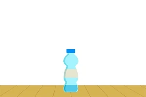 Hình ảnh của một chai nước màu xanh đứng trên sàn gỗ với nền trắng
