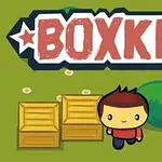 Một nhân vật hoạt hình đứng cạnh hai chiếc hộp gỗ trên nền cỏ xanh với chữ BOXKID lớn phía trên
