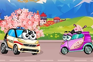 Hai chiếc xe hoạt hình với mắt to, một chiếc xe cảnh sát màu trắng và một chiếc xe màu hồng có quạt, đang ở trên con đường trước phong cảnh núi non và hoa anh đào