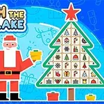 Ông già Noel cầm một món quà bên cạnh cây thông Noel được trang trí với các hình ảnh nhỏ, trên nền xanh có chữ Catch the Snowflake