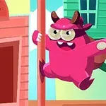 Một con quái vật màu hồng với sừng đang trèo lên cột trước tòa nhà màu hồng và xanh lục