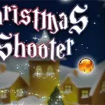 Tiêu đề Christmas Shooter với các quả cầu màu sắc trước một ngôi làng phủ tuyết vào ban đêm