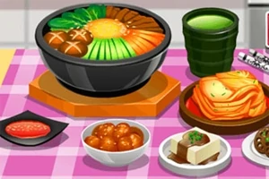 Bàn ăn với một nồi lẩu đầy nguyên liệu, cùng với các món phụ như kimchi, đậu phụ, và một ly trà xanh trên khăn trải bàn kẻ ô màu hồng