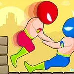 Hai nhân vật với chiếc đầu lớn và bộ trang phục màu sắc sặc sỡ đang đấu vật trên nền cát vàng