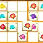 Bảng lưới với các ô vuông chứa hình ảnh của các bông hoa màu sắc khác nhau như đỏ, xanh, và tím