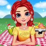 Một cô gái tóc đỏ với áo vàng ngồi trên tấm thảm picnic màu hồng, cùng một giỏ đồ ăn, trên nền cỏ xanh và bầu trời trong xanh