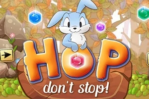 Một chú thỏ xanh đáng yêu ngồi trên chữ HOP được viền màu cam, xung quanh là các viên đá quý nhiều màu sắc trong khung cảnh rừng thu lá vàng