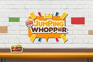 Biển hiệu Jumping Whopper với biểu tượng vương miện, có logo Burger King trên tường gạch trắng và hình ảnh chiếc bánh burger ở phía dưới