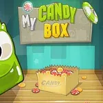 Hình ảnh chứa một nhân vật màu xanh lá cây bên cạnh một hộp kẹo với nhiều viên kẹo xung quanh, kèm theo dòng chữ My Candy Box