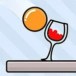 Hình ảnh quả bóng màu cam gần ly rượu chứa chất lỏng đỏ, nằm trên bề mặt màu xám