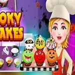 Một đầu bếp đội mũ trắng cầm khay bánh cupcake trang trí theo chủ đề Halloween với nhiều màu sắc và biểu cảm khác nhau