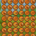 Bức ảnh hiển thị một lưới các đồng xu màu cam, mỗi đồng xu có hình ảnh một con ốc sên, bánh kếp, và một chai siro
