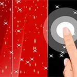 Một ngón tay chạm vào điểm sáng trên nền màu đen và đỏ với các hạt sáng lấp lánh