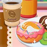 Đĩa trên bàn có bánh doughnut phủ kem sô cô la và vani, lát kiwi, miếng cam, quả anh đào và cốc cà phê bên cạnh